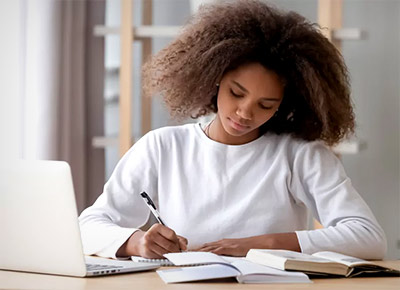 African-American college student studying with laptop