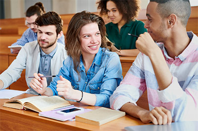 College Students in classroom with textbooks