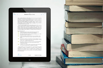 e-Reader showing e-Book beside textbooks