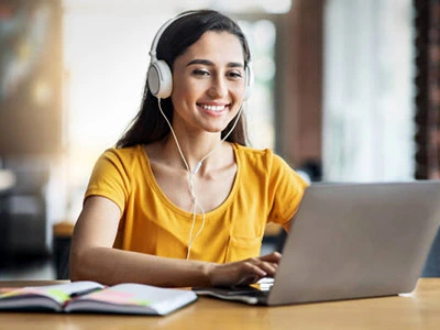 College woman studying on laptop