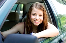 Young college student driving a car