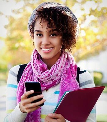 Female student enjoying smartphone