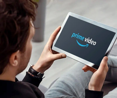 Young male college student streaming Amazon Prime Video on tablet device