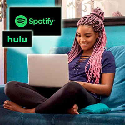 Female College Student streaming Spotify and Hulu on Laptop