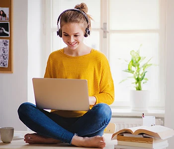 Female student doing online college class on laptop